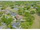 Aerial view of a neighborhood, golf course, and lake at 4033 Priory Cir, Tampa, FL 33618