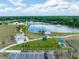 An aerial view showcasing a community park with a picturesque lake, walking paths and lush green spaces at 4033 Priory Cir, Tampa, FL 33618