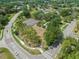 An aerial view showcasing community tennis courts surrounded by lush trees and winding roads at 4033 Priory Cir, Tampa, FL 33618