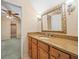 Bathroom with granite countertops, wood cabinetry, and ornate mirror at 4033 Priory Cir, Tampa, FL 33618
