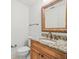 Elegant powder room featuring granite countertop, wood cabinets, and decorative mirror at 4033 Priory Cir, Tampa, FL 33618