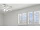 Bright bedroom featuring white shutters and a ceiling fan at 4033 Priory Cir, Tampa, FL 33618