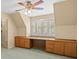 Bedroom featuring built-in desk, wooden cabinets, window shutters, and ceiling fan at 4033 Priory Cir, Tampa, FL 33618