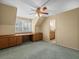 Bedroom with built-in desk, wooden cabinets, shutters, and a ceiling fan at 4033 Priory Cir, Tampa, FL 33618