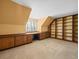 Bedroom featuring built-in desk, cabinetry, shelving, window shutters, and carpeted floors at 4033 Priory Cir, Tampa, FL 33618
