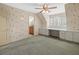 Bedroom with built-in desk, ceiling fan, shutters, and access to a bathroom at 4033 Priory Cir, Tampa, FL 33618