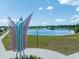 Scenic view of a community lake featuring a lighted fountain and a boardwalk in a well-maintained park at 4033 Priory Cir, Tampa, FL 33618