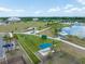 An aerial view of the community park and recreational area with a lake, fitness equipment, and walking paths at 4033 Priory Cir, Tampa, FL 33618