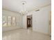 Dining room showcases a chandelier and shutters in a neutral color scheme at 4033 Priory Cir, Tampa, FL 33618