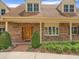 Close-up of a brick home's entrance, showcasing a wooden door and manicured greenery at 4033 Priory Cir, Tampa, FL 33618
