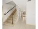 Bright entryway with tile floors, staircase, and chandelier-lit hallway leading to glass doors at 4033 Priory Cir, Tampa, FL 33618