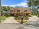 Beautiful brick two-story home with a circular driveway, mature landscaping, and a well-maintained lawn at 4033 Priory Cir, Tampa, FL 33618