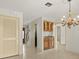 A bright kitchen with wood cabinets, granite countertops, and stylish chandelier at 4033 Priory Cir, Tampa, FL 33618