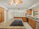 Bright kitchen featuring granite counters, stainless steel appliances, and a central island cooktop at 4033 Priory Cir, Tampa, FL 33618