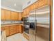 Modern kitchen featuring granite countertops, stainless steel refrigerator, and built in appliances at 4033 Priory Cir, Tampa, FL 33618