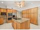 Kitchen boasts a large island with adjacent cabinets and stainless fridge at 4033 Priory Cir, Tampa, FL 33618