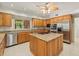 Bright kitchen boasts stainless steel appliances, granite countertops, and a functional central island at 4033 Priory Cir, Tampa, FL 33618