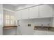 Practical laundry room with upper cabinets and utility sink at 4033 Priory Cir, Tampa, FL 33618