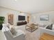Comfortable living room with ample seating, view to back patio, and open floor plan at 4033 Priory Cir, Tampa, FL 33618