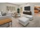 Bright living room with large windows, comfortable seating, and access to the outdoors at 4033 Priory Cir, Tampa, FL 33618