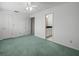 Main bedroom features green carpet, two closets, and access to the en suite bathroom at 4033 Priory Cir, Tampa, FL 33618