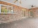 Covered brick patio with access to the lawn and golf course at 4033 Priory Cir, Tampa, FL 33618