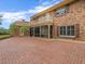 Brick home featuring a balcony, screened-in porch, and brick patio at 4033 Priory Cir, Tampa, FL 33618