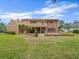 Brick home with a screened-in porch, balcony, and landscaped backyard at 4033 Priory Cir, Tampa, FL 33618