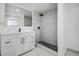Modern bathroom featuring marble shower, black fixtures, and white vanity at 4519 5Th S Ave, St Petersburg, FL 33711