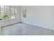 Bright bedroom featuring large windows and modern gray tile flooring at 4519 5Th S Ave, St Petersburg, FL 33711
