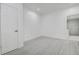 Bedroom with white walls and tile flooring, featuring a door to the bathroom for convenience at 4519 5Th S Ave, St Petersburg, FL 33711
