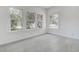 Bright bedroom featuring large windows and modern gray tile flooring at 4519 5Th S Ave, St Petersburg, FL 33711