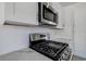 Close-up of a stainless steel gas range with marble counter and microwave at 4519 5Th S Ave, St Petersburg, FL 33711