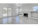 Bright living room featuring a decorative fireplace, built-in shelves, and ample natural light at 4519 5Th S Ave, St Petersburg, FL 33711