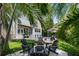 Beautiful backyard with a sparkling pool, outdoor seating, and verdant landscaping at 4804 W Beachway Dr, Tampa, FL 33609