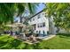 Expansive backyard with a pool, lounge areas, and meticulously maintained landscaping at 4804 W Beachway Dr, Tampa, FL 33609