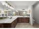 Large bathroom with dual vanities, mirrors, and plenty of counter space, and a glass enclosed shower at 4804 W Beachway Dr, Tampa, FL 33609