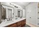 Contemporary bathroom featuring double sinks, sleek lighting, and a walk-in shower at 4804 W Beachway Dr, Tampa, FL 33609