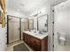 Modern bathroom with walk-in shower, double sinks, and neutral color palette at 4804 W Beachway Dr, Tampa, FL 33609