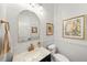 Powder room features a marble countertop, dark wood vanity and decorative fixtures at 4804 W Beachway Dr, Tampa, FL 33609