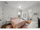 Cozy bedroom with pink bedding, hardwood floors, and natural light from the window at 4804 W Beachway Dr, Tampa, FL 33609