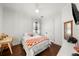 Bright bedroom featuring a white ceiling fan, dark hardwood floors, and neutral walls at 4804 W Beachway Dr, Tampa, FL 33609