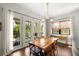 Sunlit dining area with french doors opening to a backyard patio features a wooden table at 4804 W Beachway Dr, Tampa, FL 33609