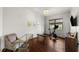 Well-lit exercise room with hardwood floors, a stationary bike, and a comfortable seating area at 4804 W Beachway Dr, Tampa, FL 33609