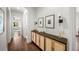 Elegant hallway with wooden cabinet and stylish sconces, leading to a bright living space at 4804 W Beachway Dr, Tampa, FL 33609