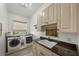 Bright laundry room with front loading washer/dryer, granite countertops, and lovely views at 4804 W Beachway Dr, Tampa, FL 33609