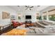 Sun-filled living room with hardwood floors, large windows, and comfortable seating perfect for relaxation at 4804 W Beachway Dr, Tampa, FL 33609