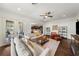 Bright living room with hardwood floors, comfortable seating, and French doors opening to the outdoors at 4804 W Beachway Dr, Tampa, FL 33609
