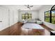 Bright living room with hardwood floors, large windows, and a cozy gray sectional at 4804 W Beachway Dr, Tampa, FL 33609