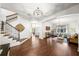 Spacious living room with wood floors, staircase, and arched doorways offers an inviting atmosphere at 4804 W Beachway Dr, Tampa, FL 33609